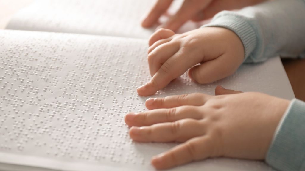 blind child reading braille