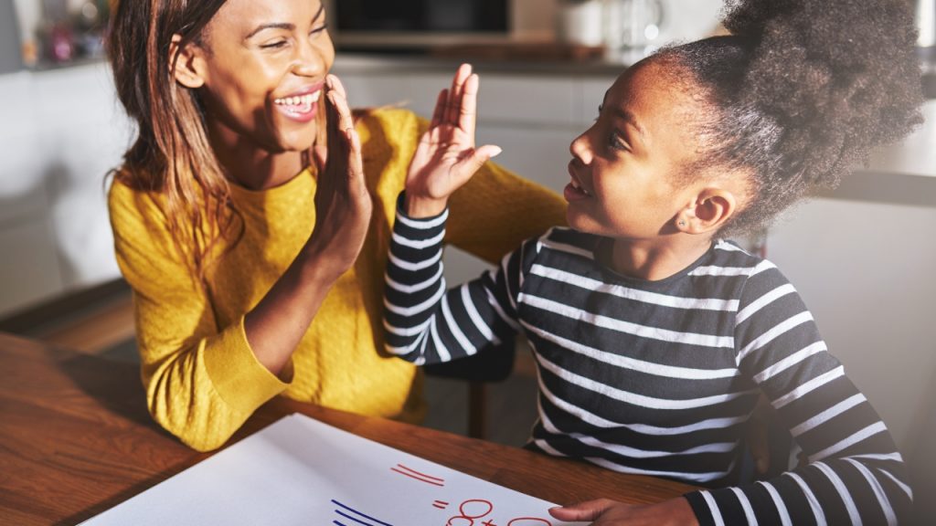 homeschooling mom and daughter high-five